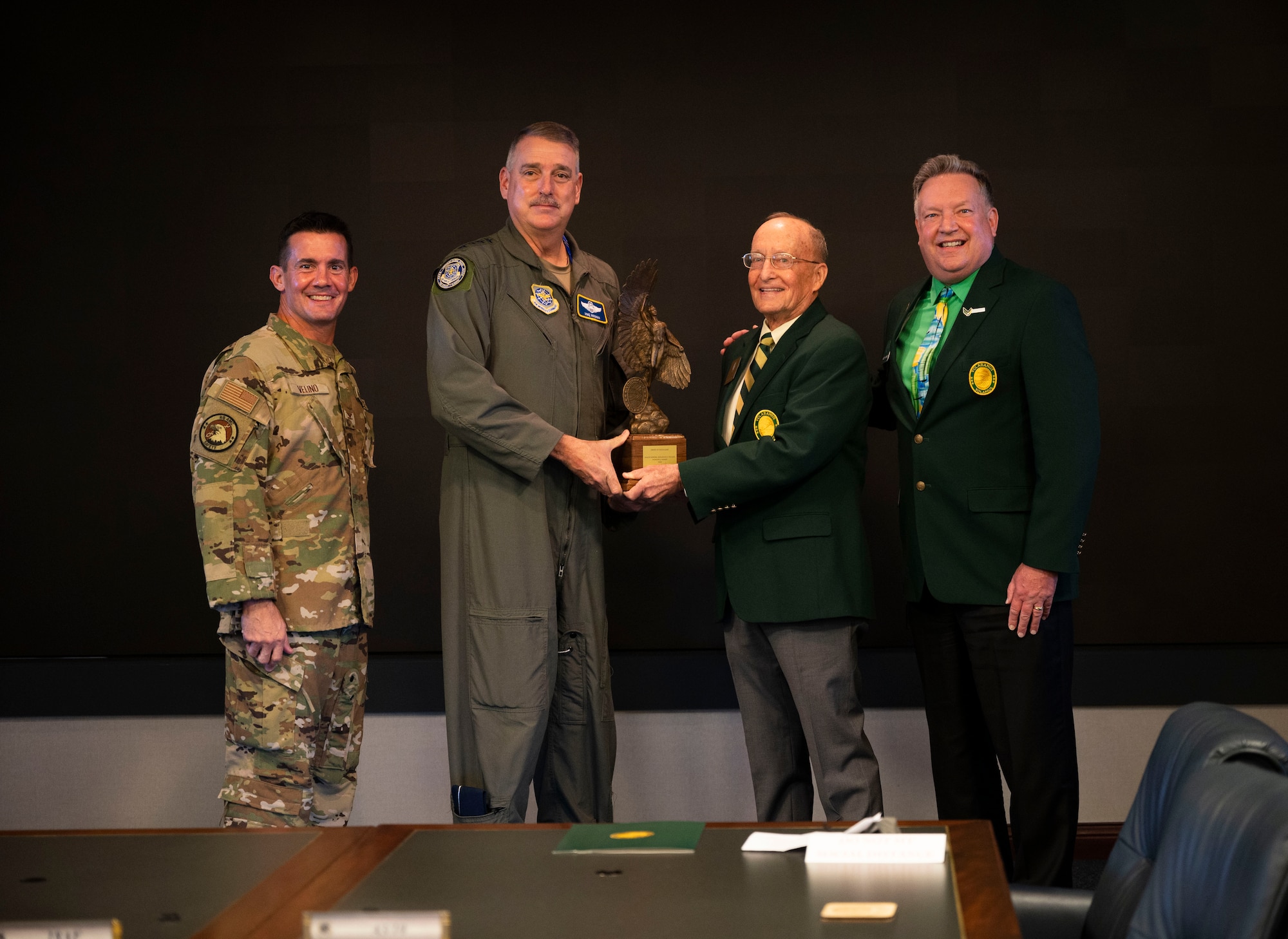Mr. John “Woody” Almind, right, local Flight Captain for the 26th Gateway Flight Order of Daedalians, and Maj Gen (ret) Jerry Allen, second from right, Chairman of the Daedalian Foundation Board of Trustees, present the 2020 Major General Benjamin D. Foulois Memorial Award to Gen. Mike Minihan, second from left, Air Mobility Command commander, and Col. Charles Velino, left, AMC Directory of Safety, at Scott Air Force Base, Illinois, Nov. 16, 2021.