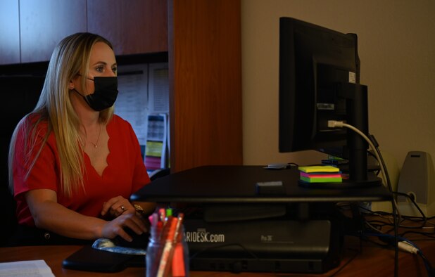 Kayli Bates, Space Launch Delta 30 information protection office personnel security program manager, Oct. 27, 2021, at Vandenberg Space Force Base, Calif. Bates is working on her computer handling all matters from security clearances to debt delinquencies, as well as, any abuse to drugs and alcohol. (U.S. Space Force photo by Airman First Class Tiarra Sibley)