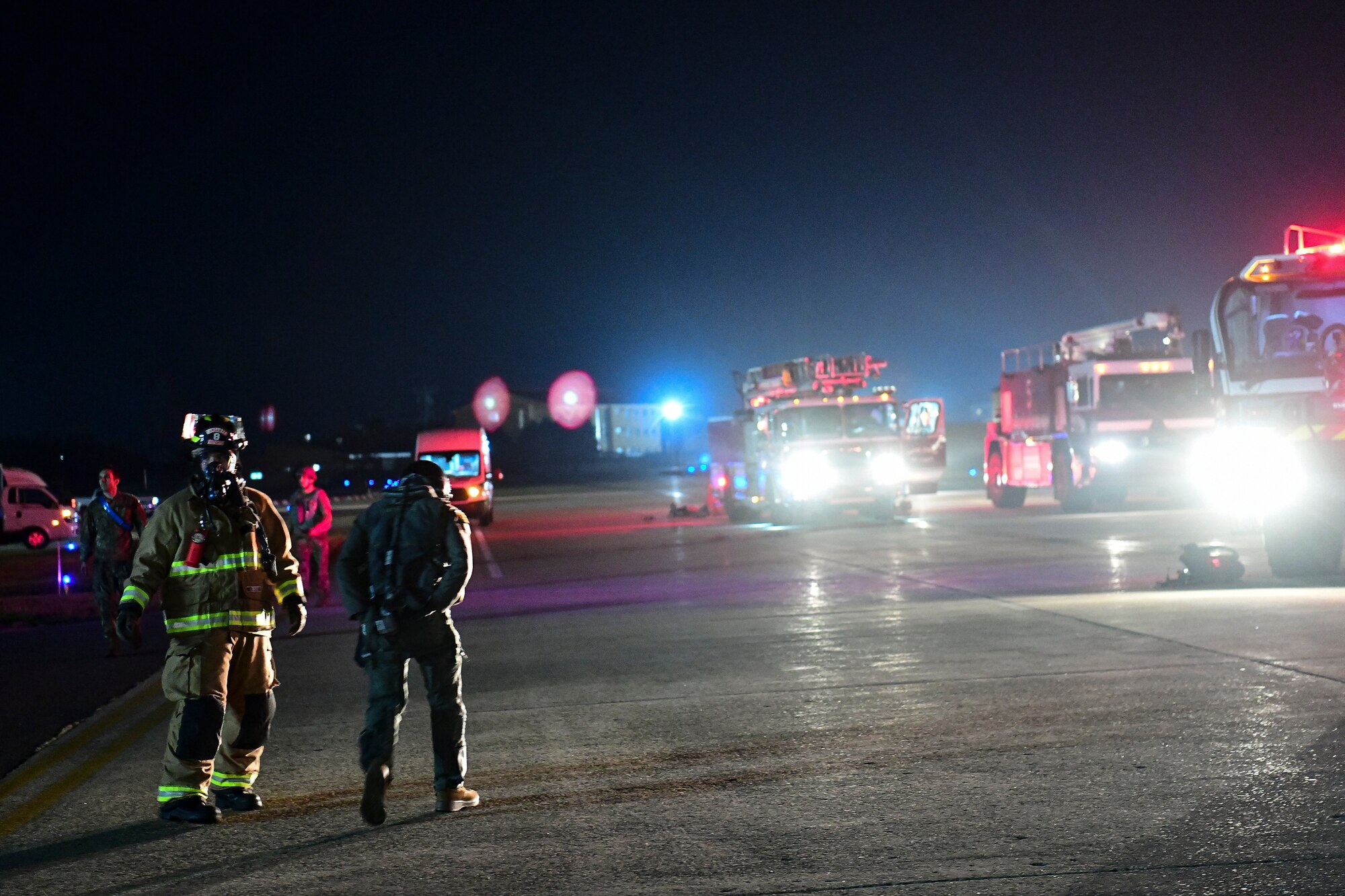 A firefighter escorts a pilot.
