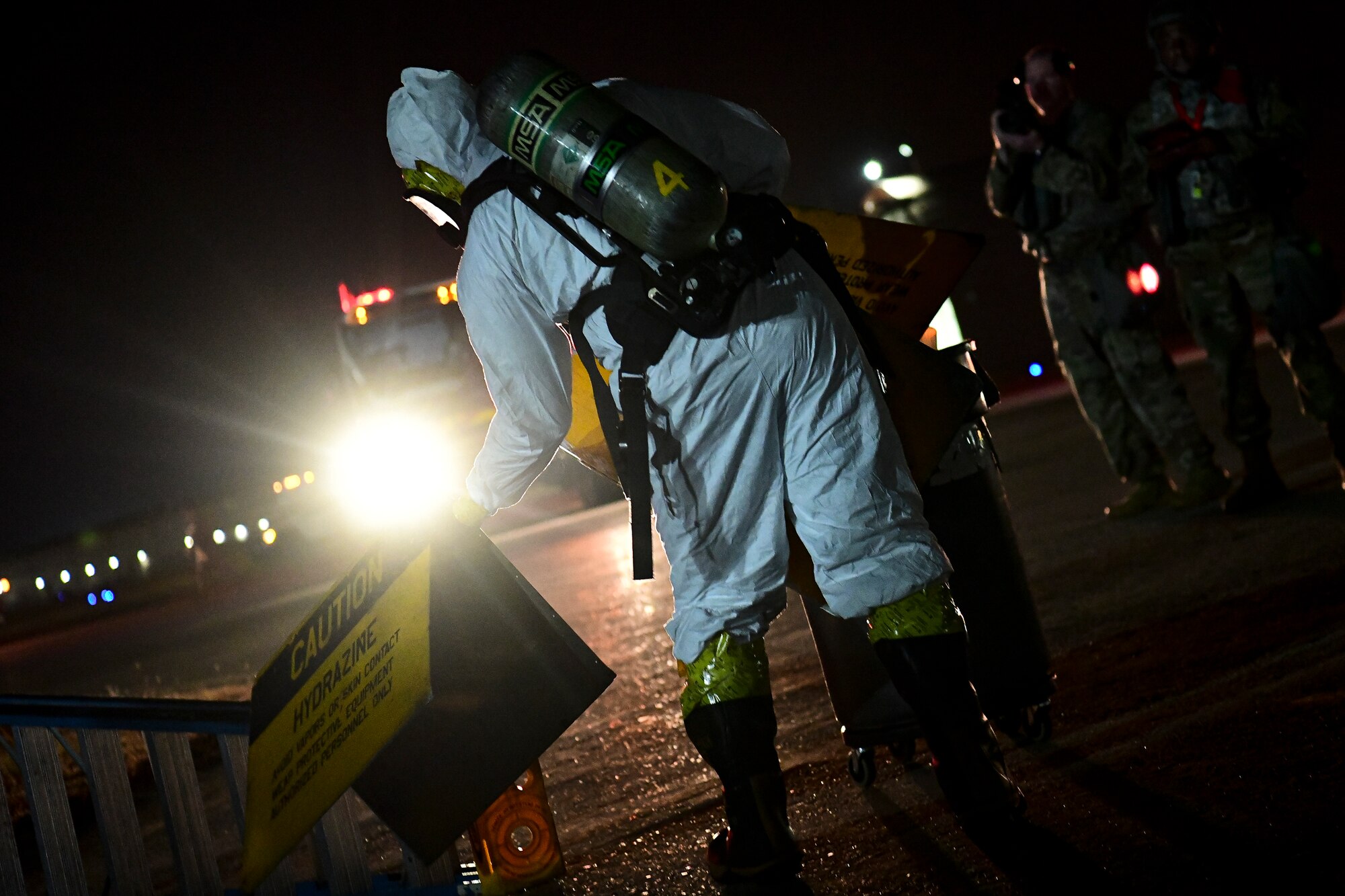 An Airmen sets a caution sign.