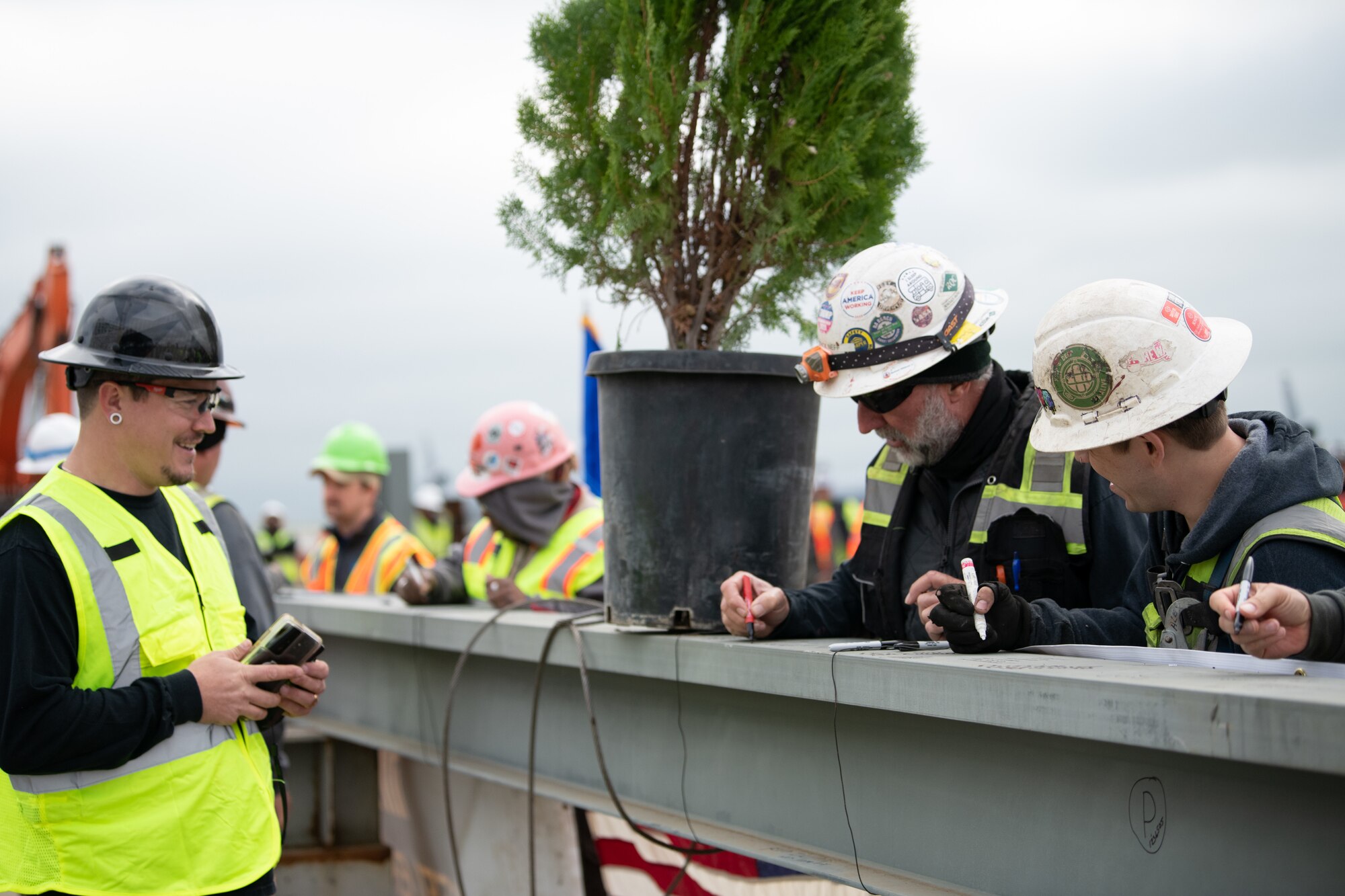 construction workers attend topping out ceremony