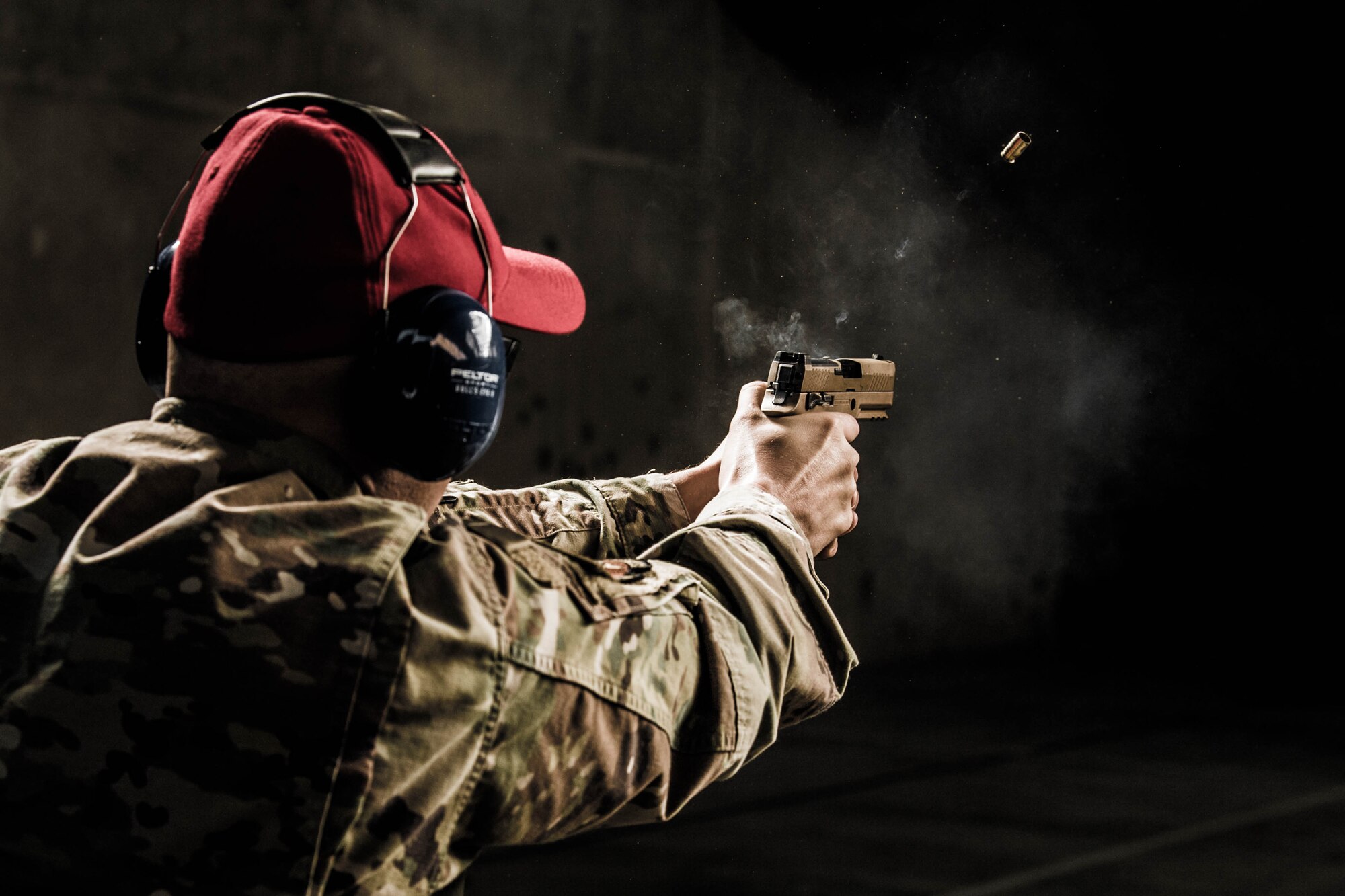 Tech. Sgt. Justin Block, 436th Security Forces Squadron combat arms noncommissioned officer in charge, fires an M18 pistol Nov. 8, 2021, at Dover Air Force Base, Delaware. Each year approximately 1,700 personnel receive training and qualification at the Dover AFB Combat Arms Training and Maintenance facility. (U.S. Air Force photo by Mauricio Campino)