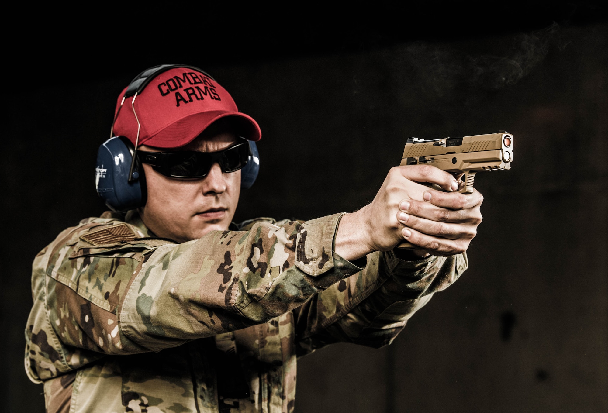 Tech. Sgt. Justin Block, 436th Security Forces Squadron combat arms noncommissioned officer in charge, fires an M18 pistol Nov. 8, 2021, at Dover Air Force Base, Delaware. Each year approximately 1,700 personnel receive training and qualification at the Dover AFB Combat Arms Training and Maintenance facility. (U.S. Air Force photo by Mauricio Campino)