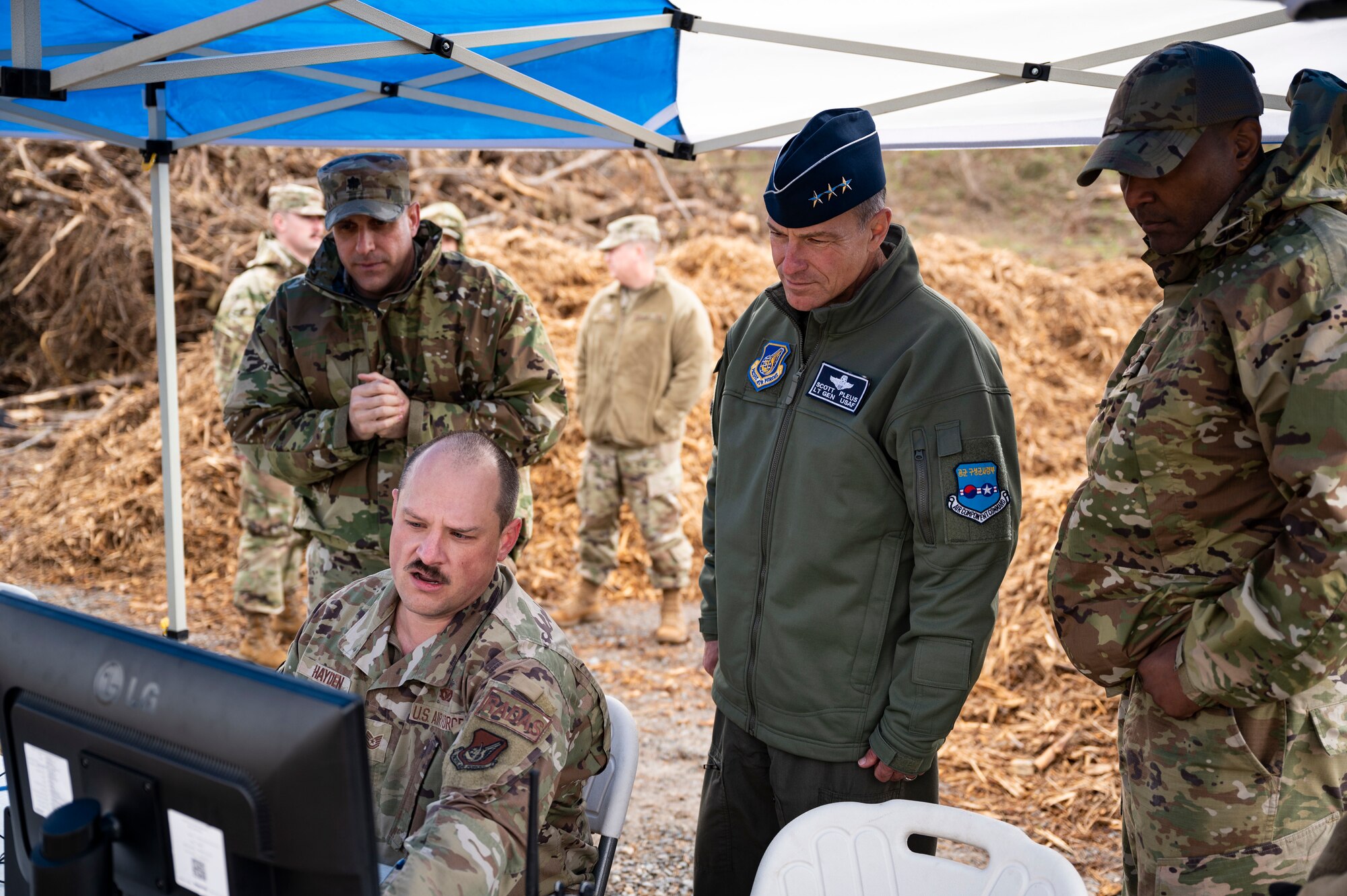Tech. Sgt. William Hayden, 8th Civil Engineer Squadron construction manager, demonstrates the Rapid Airfield Damage Assessment System capabilities to Lt. Gen. Scott Pleus, Seventh Air Force commander, and Chief Master Sgt. Alvin Dyer, Seventh Air Force command chief, at Kunsan Air Base, Republic of Korea, Nov. 10, 2021.