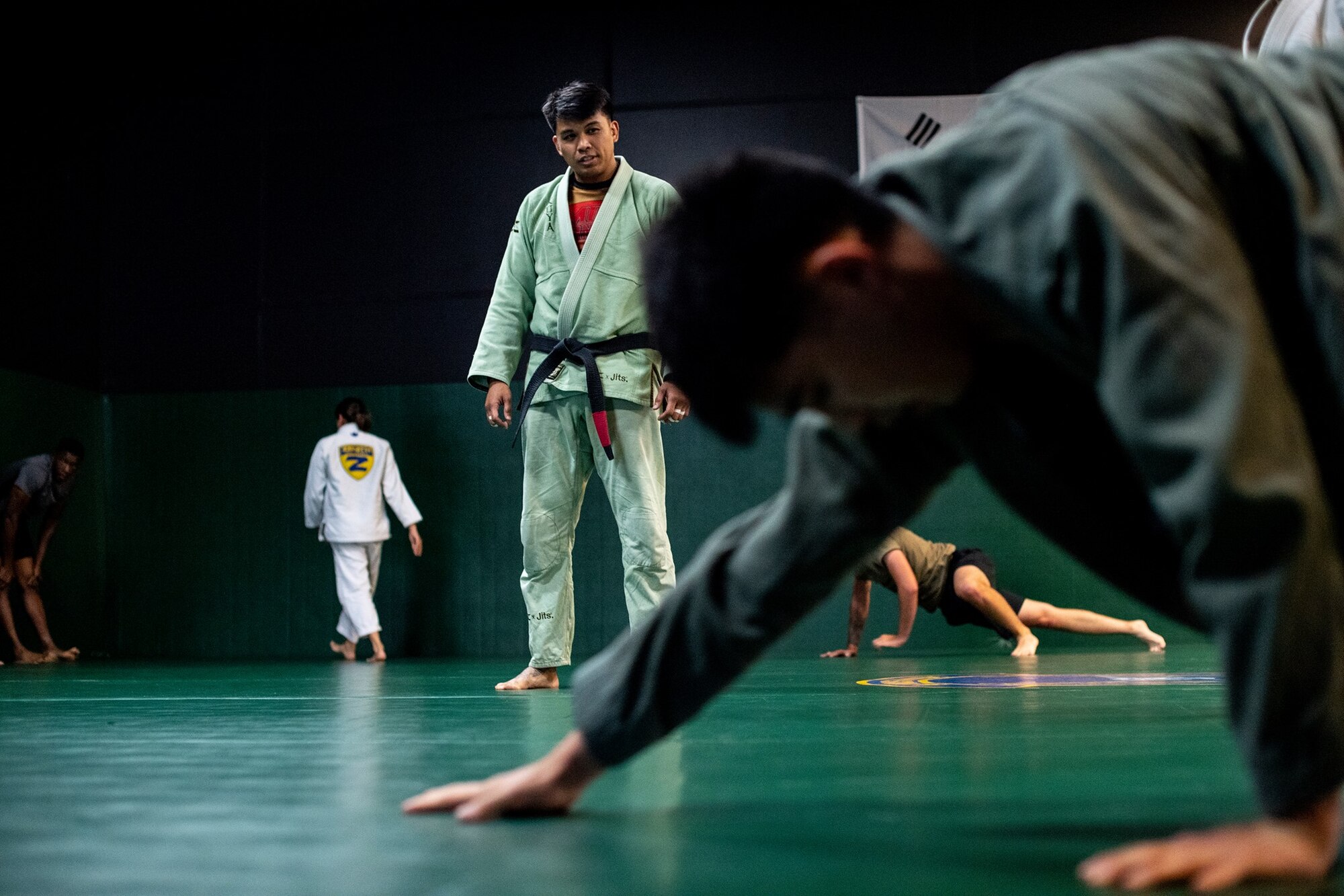 Master Sergeant Christopher Costa, 607th Air Support Operations Group section chief, watches students perform warm-up exercises as he leads a Brazilian Jui Jitsu class at Osan Air Base, Republic of Korea. The class is designed to develop and equip participants of all ranks and backgrounds with the necessary tools to develop physically and mentally.
