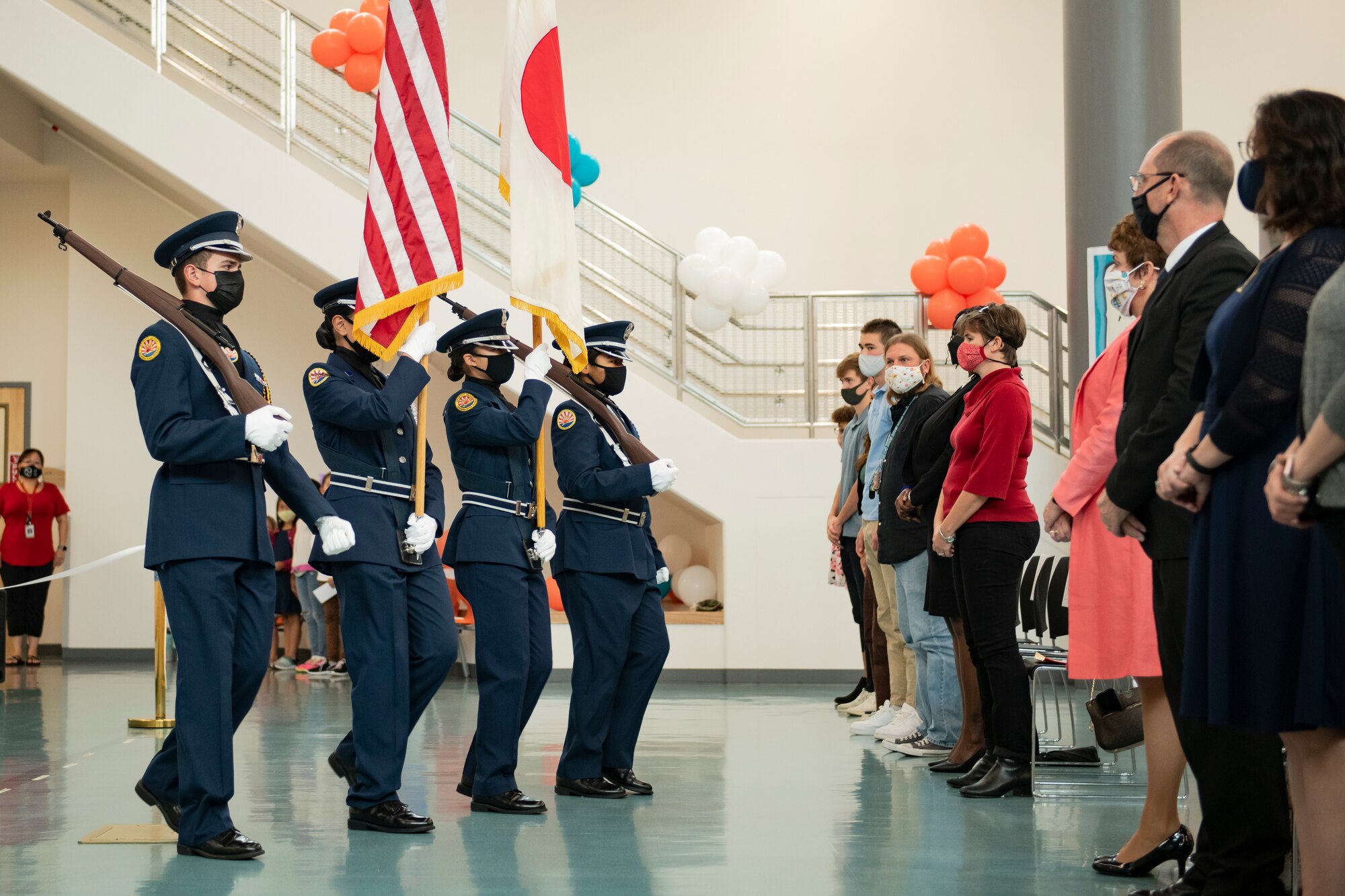 Members of the Kadena High School Junior Reserve Officer Training Corps Color Guard get into position for the playing of the National Anthems of Japan and the United States during the Bob Hope Elementary School ribbon cutting ceremony at Kadena Air Base, Japan, Nov. 9, 2021. The school was designed with flexible spacing and classrooms with moveable walls to better accommodate team-teaching methods and flexible class sizes. (U.S. Air Force photo by Senior Airman Jessi Monte)