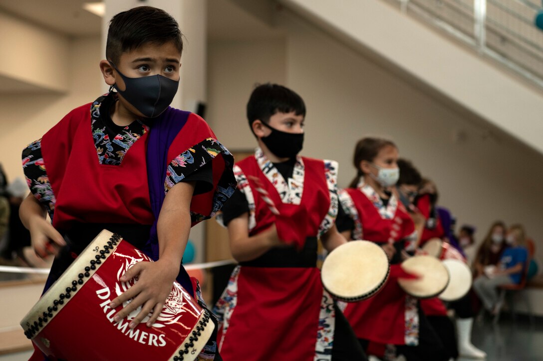 The Amelia Earhart Intermediate School Firebird Drummers perform during the Bob Hope Elementary School ribbon cutting ceremony at Kadena Air Base, Japan, Nov. 9, 2021. The ceremony also featured several speakers who shared memories of their experiences at Department of Defense Education Activity schools and their hopes for the future of BHES students. (U.S. Air Force photo by Senior Airman Jessi Monte)