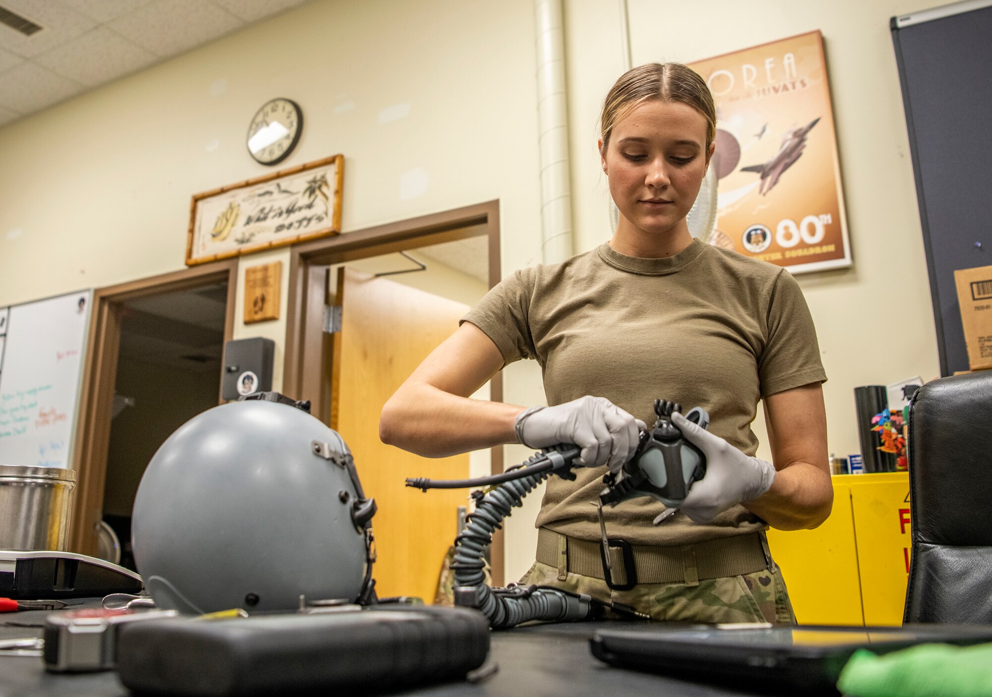 Senior Airman Samantha Anderson, 80th Fighter Squadron aircrew flight equipment technician, disassembles an oxygen mask at Kunsan Air Base, Republic of Korea, Nov. 8, 2021. From packing emergency items like parachutes and survival kits to maintaining regularly used items like oxygen masks, the attention to detail by these Airmen could mean the difference between life and death. (U.S. Air Force photo Staff Sgt. Jesenia Landaverde)