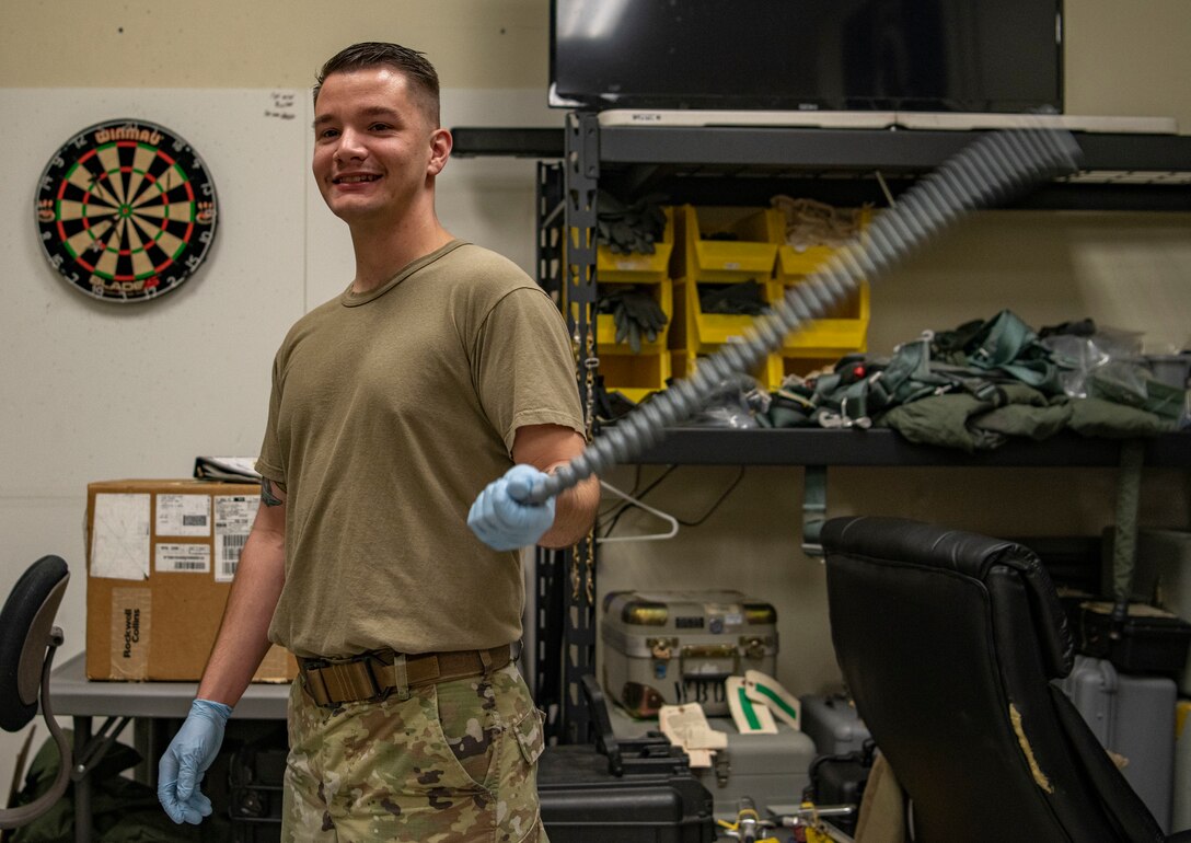 Senior Airman Cameron Nixon, 80th Fighter Squadron aircrew flight equipment technician, drys off an oxygen delivery tube from the flight helmet oxygen mask at Kunsan Air Base, Republic of Korea, Nov. 8, 2021. From packing emergency items like parachutes and survival kits to maintaining regularly used items like oxygen masks, the attention to detail by these Airmen could mean the difference between life and death. (U.S. Air Force photo  Staff Sgt. Jesenia Landaverde)