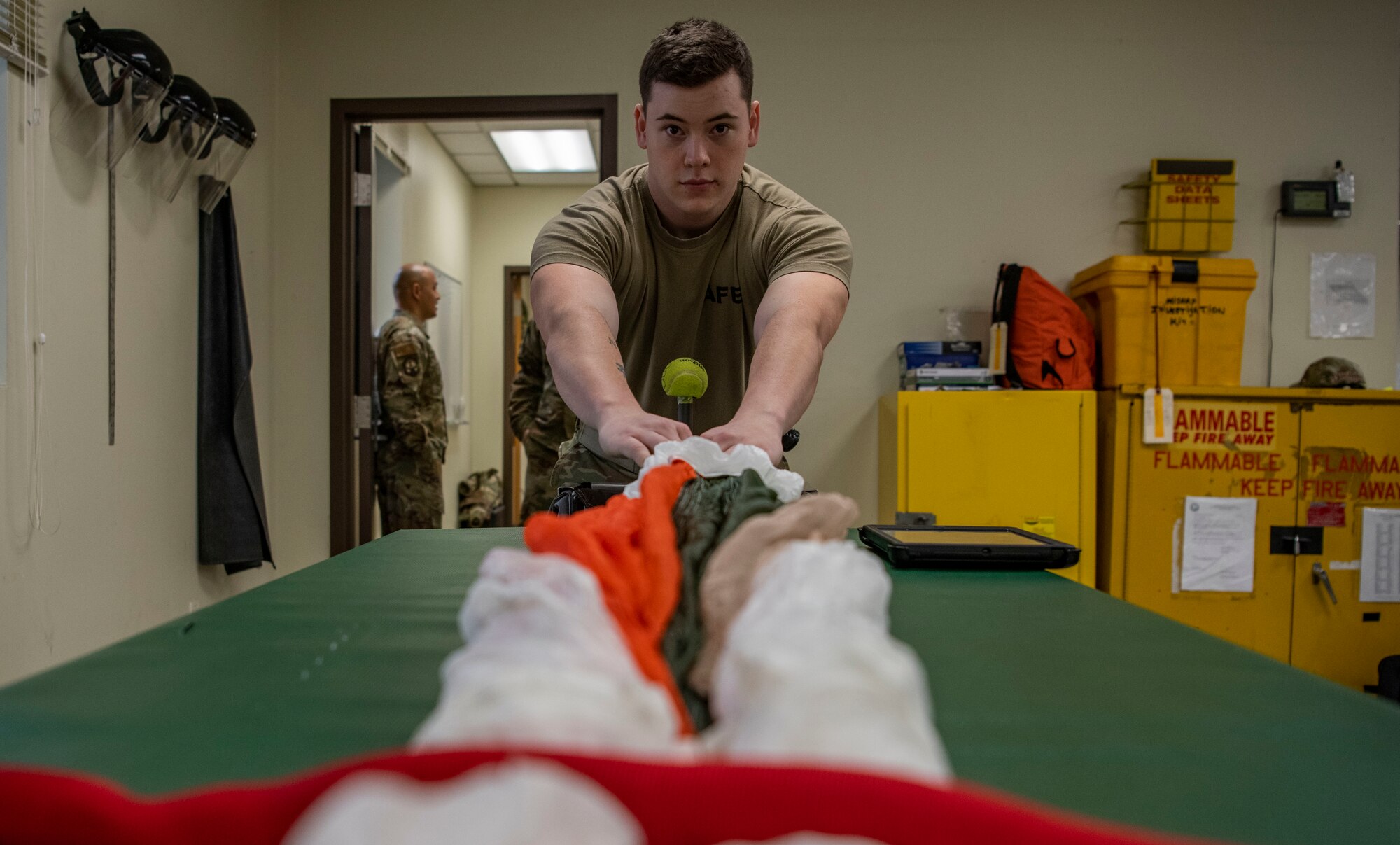 Senior Airman Colton Knight, 8th Operation Support Squadron aircrew flight equipment technician, pulls a parachute at Kunsan Air Base, Republic of Korea, Nov. 8, 2021. Aircrew Flight Equipment specialists make sure flyers have the supplies necessary for ensuring that all flight and safety equipment is in the perfect working order. (U.S. Air Force photo Staff Sgt. Jesenia Landaverde)