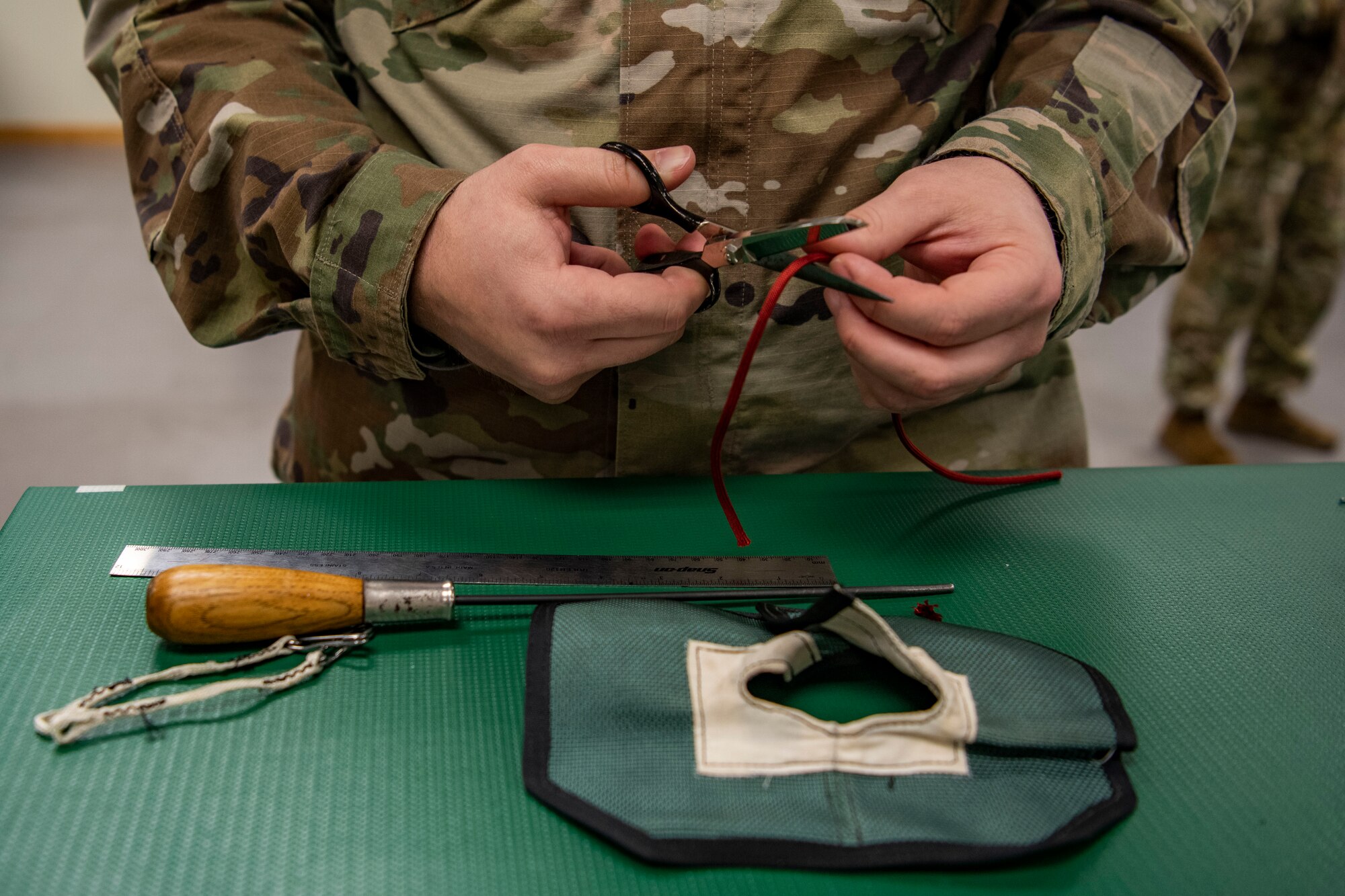 Senior Airman Joseph Crestik, 8th Operation Support Squadron aircrew flight equipment technician, sews a locking loop at Kunsan Air Base, Republic of Korea, Nov. 8, 2021. Aircrew Flight Equipment specialists make sure flyers have the supplies necessary for ensuring that all flight and safety equipment is in the perfect working order. (U.S. Air Force photo Staff Sgt. Jesenia Landaverde)