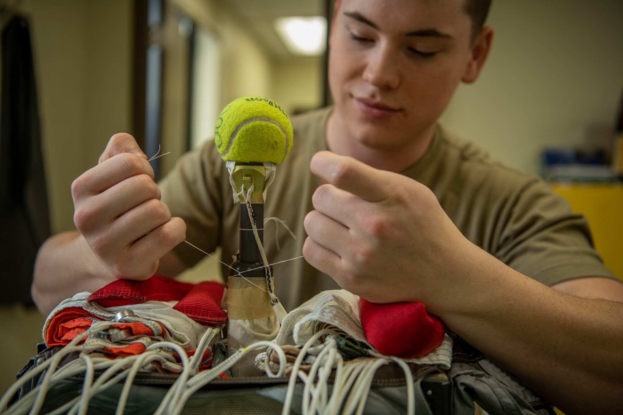 Senior Airman Martin Coetzee, 8th Operation Support Squadron aircrew flight equipment technician, sprays soap solution on an anti-exposure flight dry suit to test for leaks at Kunsan Air Base, Republic of Korea, Nov. 8, 2021. From packing emergency items like parachutes and survival kits to maintaining regularly used items like oxygen masks, the attention to detail by these Airmen could mean the difference between life and death. (U.S. Air Force photo Staff Sgt. Jesenia Landaverde)