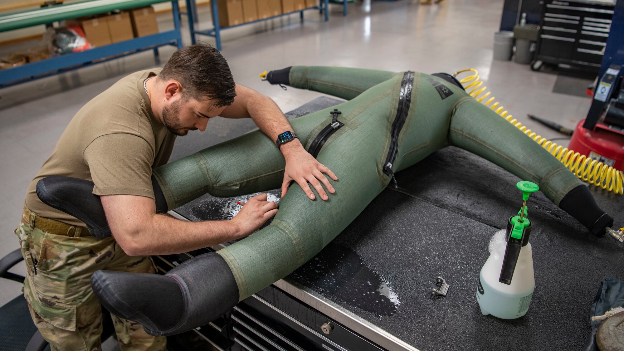 Senior Airman Martin Coetzee, 8th Operation Support Squadron aircrew flight equipment technician, marks on an anti-exposure flight dry suit after finding a leak at Kunsan Air Base, Republic of Korea, Nov. 8, 2021. From packing emergency items like parachutes and survival kits to maintaining regularly used items like oxygen masks, the attention to detail by these Airmen could mean the difference between life and death. (U.S. Air Force photo Staff Sgt. Jesenia Landaverde)
