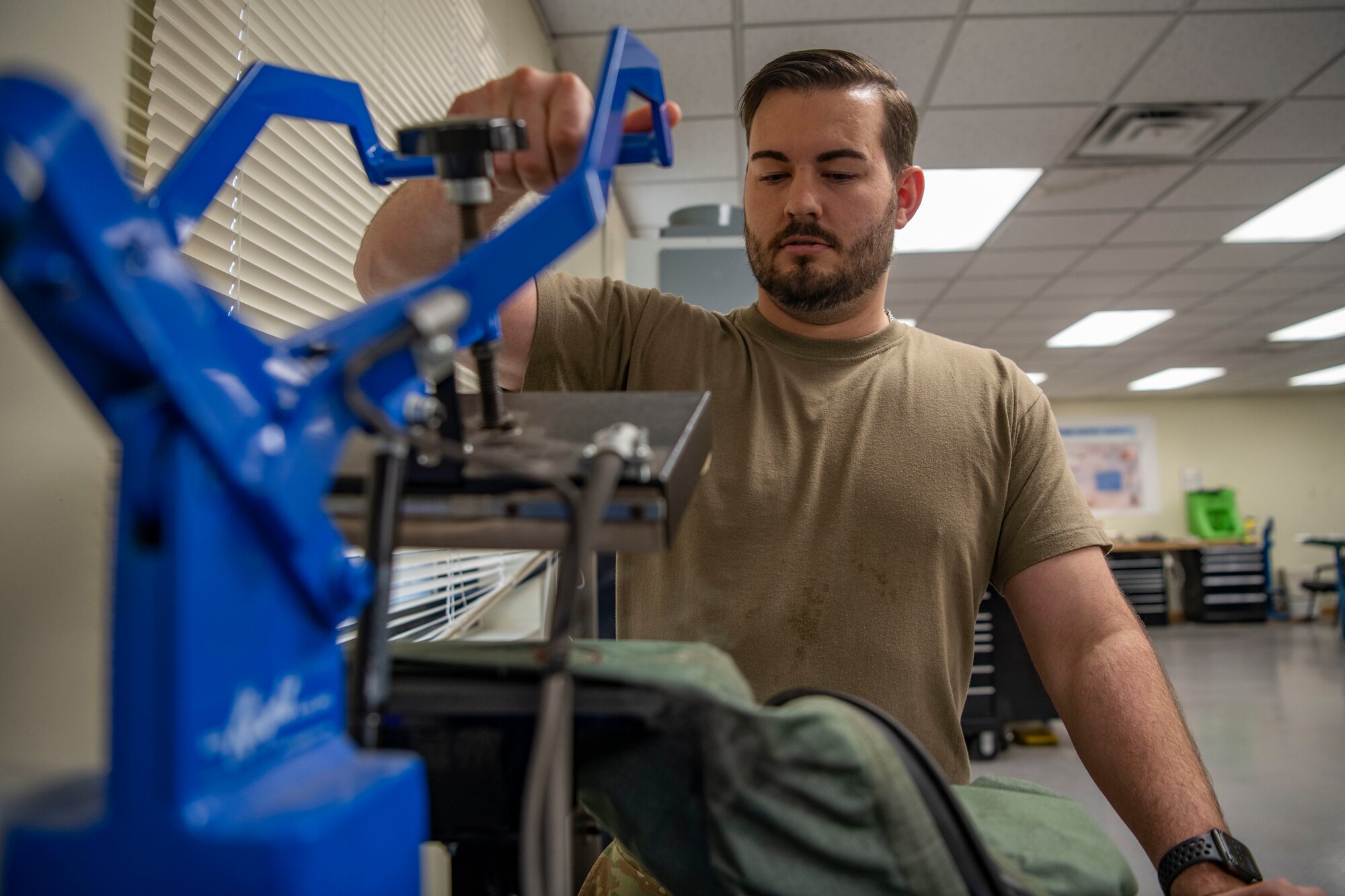 Senior Airman Martin Coetzee, 8th Operation Support Squadron aircrew flight equipment technician, hot presses on seal tape for an anti-exposure flight dry suit at Kunsan Air Base, Republic of Korea, Nov. 8, 2021. From packing emergency items like parachutes and survival kits to maintaining regularly used items like oxygen masks, the attention to detail by these Airmen could mean the difference between life and death. (U.S. Air Force photo Staff Sgt. Jesenia Landaverde)