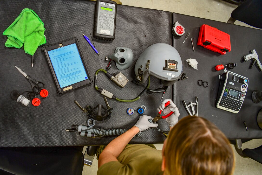 Senior Airman Samantha Anderson, 80th Fighter Squadron aircrew flight equipment technician, disassembles an oxygen mask at Kunsan Air Base, Republic of Korea, Nov. 8, 2021. There are AFE Airmen at each Kunsan Air Base flying squadron to provide support to that specific squadron’s mission with instructions on how to inspect and maintain gear. (U.S. Air Force photo Staff Sgt. Jesenia Landaverde)