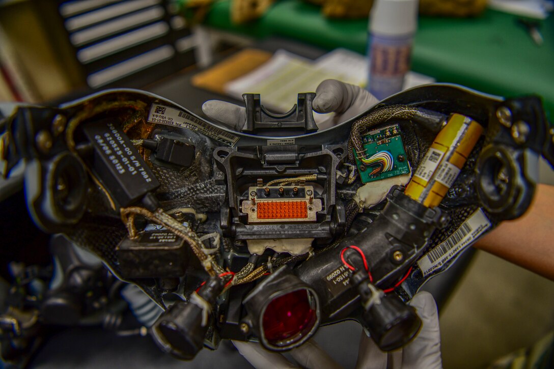 Senior Airman Samantha Anderson, 80th Fighter Squadron aircrew flight equipment technician, inspects a joint helmet mounted hueing system at Kunsan Air Base, Republic of Korea, Nov. 8, 2021. From packing emergency items like parachutes and survival kits to maintaining regularly used items like oxygen masks, the attention to detail by these Airmen could mean the difference between life and death. (U.S. Air Force photo Staff Sgt. Jesenia Landaverde)