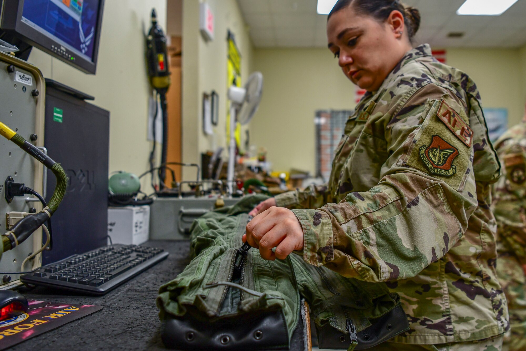 Staff Sgt. Elissa Black, 80th Fighter Squadron aircrew fright equipment noncommissioned officer in charge, tests the effectiveness of a flight suit at Kunsan Air Base, Republic of Korea, Nov. 8, 2021. Aircrew Flight Equipment specialists make sure flyers have the supplies necessary for ensuring that all flight and safety equipment is in the perfect working order.  (U.S. Air Force photo Staff Sgt. Jesenia Landaverde)