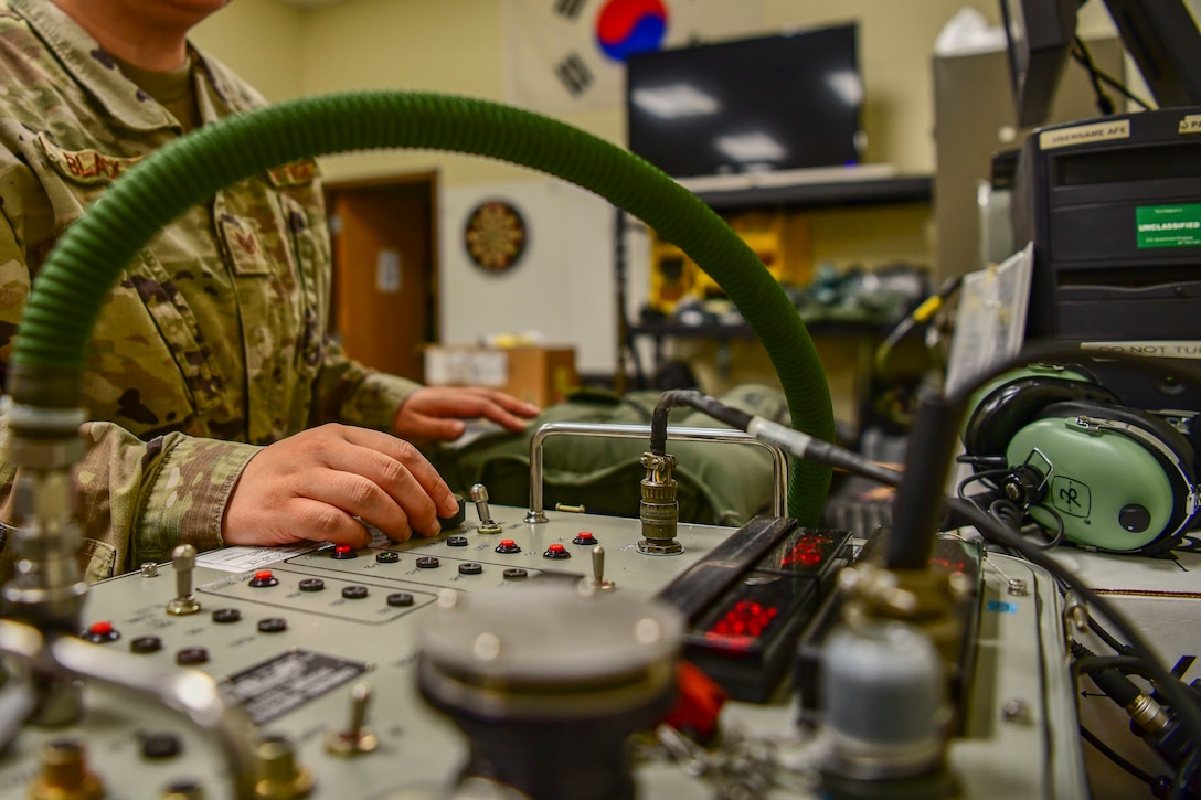 Staff Sgt. Elissa Black, 80th Fighter Squadron aircrew fright equipment noncommissioned officer in charge, tests the effectiveness of a flight suit at Kunsan Air Base, Republic of Korea, Nov. 8, 2021. There are AFE Airmen at each Kunsan Air Base flying squadron to provide support to that specific squadron’s mission with instructions on how to inspect and maintain gear. (U.S. Air Force photo Staff Sgt. Jesenia Landaverde)