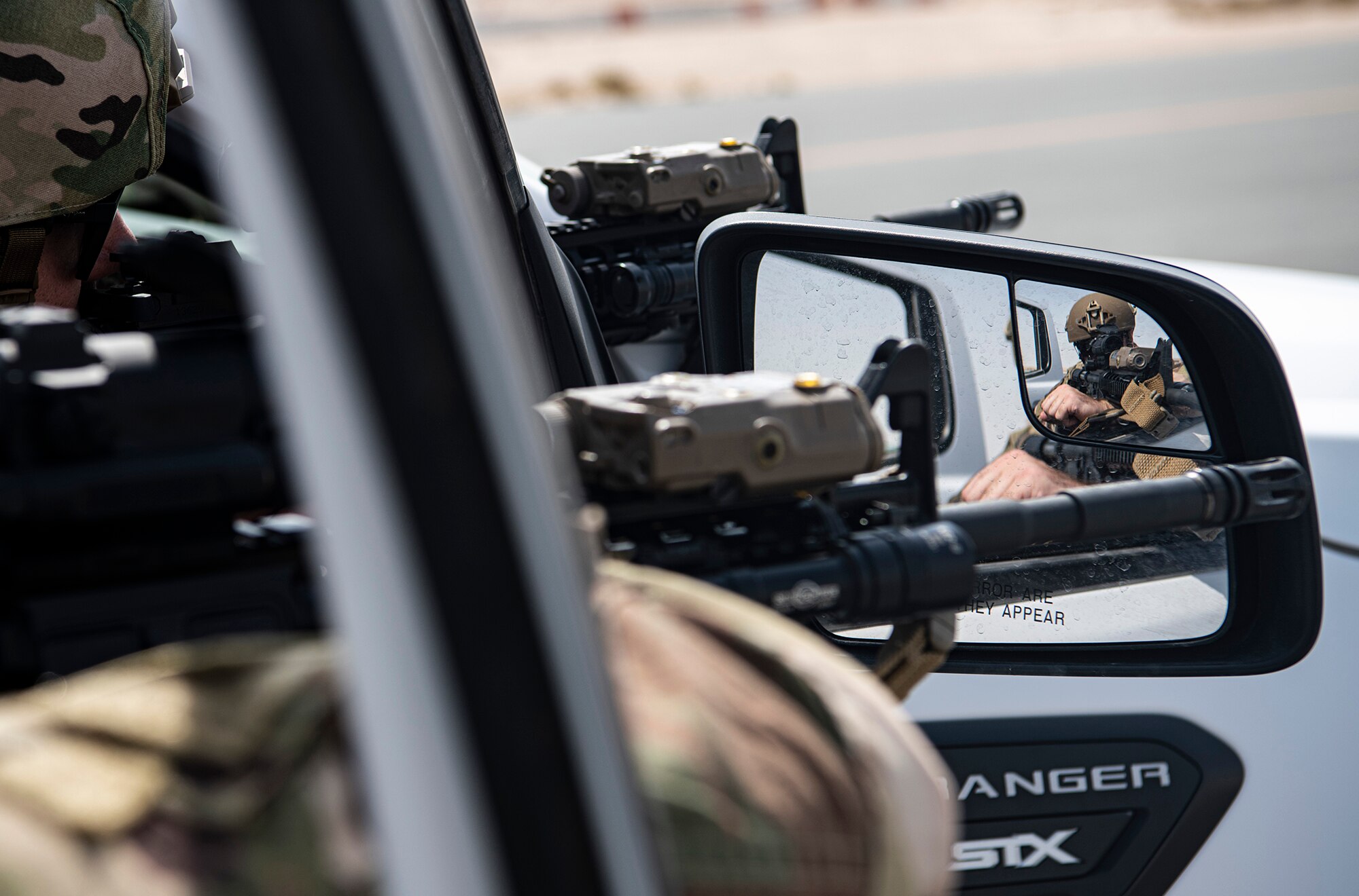 Security Forces aim weapons.
