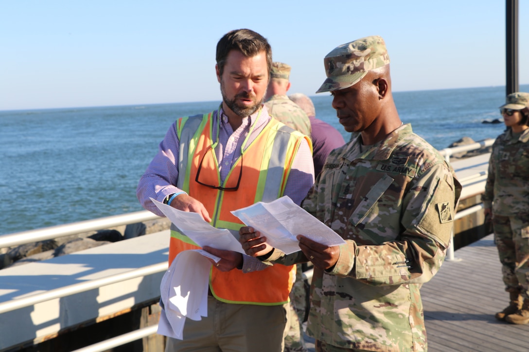 Christian Bickings, Resident Engineer of the USACE Philadelphia District Coastal New Jersey office, briefs USACE Command Sergeant Major Patrickson Toussaint on the Absecon Inlet seawall project in Atlantic City
