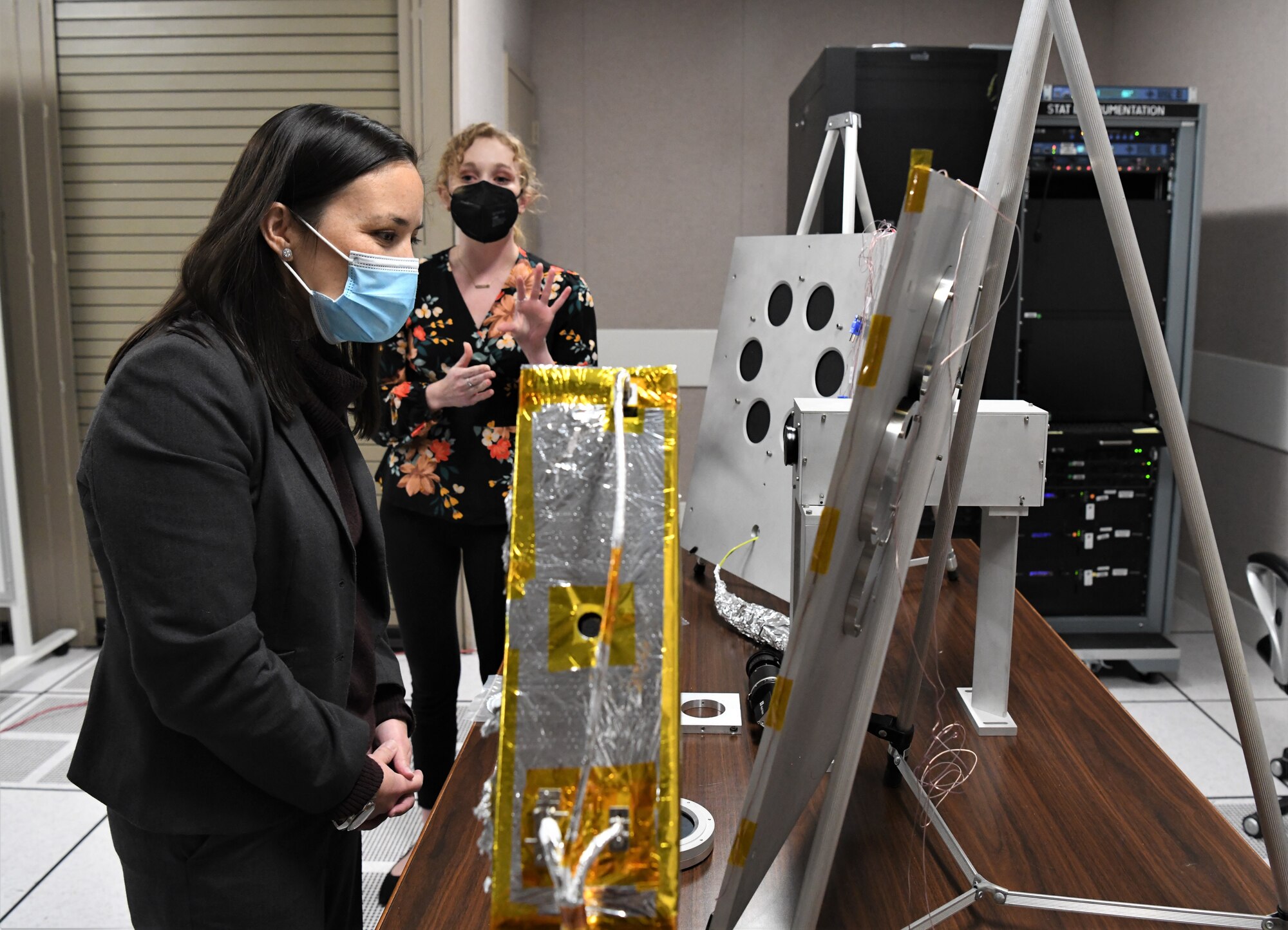Under Secretary of the Air Force Gina Ortiz Jones, looks at test samples as Savannah Langer, an engineer with the Space Test Branch, Test Division, Arnold Engineering Development Complex (AEDC), speaks about the Space Threat Assessment Testbed (STAT) in which they were tested at Arnold Air Force Base, Tenn., headquarters of AEDC, Nov. 5, 2021. STAT is used to subject test articles to environmental factors in a simulated space environment. (U.S. Air Force photo by Jill Pickett)