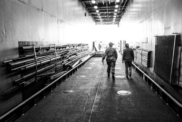 The operations officer of the amphibious dock landing ship USS Germantown (LSD 42), Lt. Melissa Johns of Kissimmee, Florida, left, gives Randi R. Cosentino, Ed.D., president of the United States Naval Community College, a tour of the ship. The USNCC is the community college of the Navy, Marine Corps, and Coast Guard and provides an opportunity for active duty enlisted Sailors, Marines and Coast Guardsmen to earn a naval-relevant associate degree through asynchronous online courses taught by military-friendly and experienced educators. (U.S. Navy photo illustration by Chief Mass Communication Specialist Xander Gamble)(This image was created in color and changed to black-and-white.)