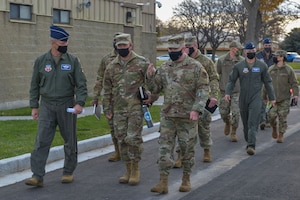 U.S. Air Force Gen. Mark Kelly, commander of Air Combat Command, and Command Chief Master Sgt. David Wade, Air Combat Command, walk to the next location during their tour on Mountain Home Air Force Base, Idaho, Nov. 8, 2021. Gen. Kelly toured the base to discuss the base’s needs and status.