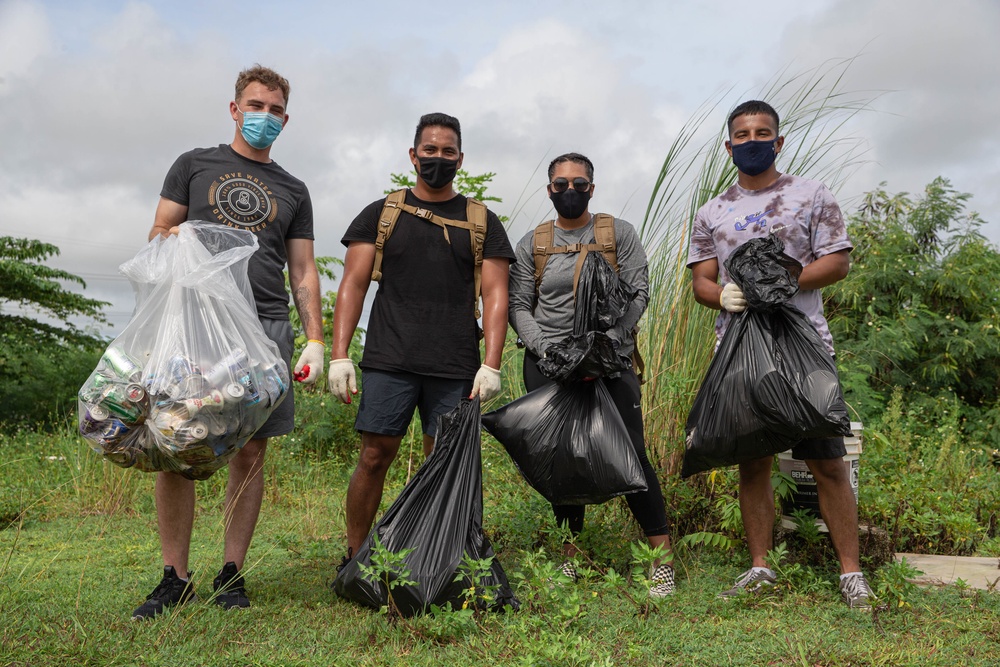 Marines collecting trash with some natives of Guam.
