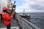 Gunner’s mates aboard Coast Guard Cutter Spencer shoot messenger lines to a disabled fishing vessel 100 miles off the coast of New York to bring the vessel in tow. (U.S. Coast Guard photo by Chief Petty Officer Katharine Ingham)