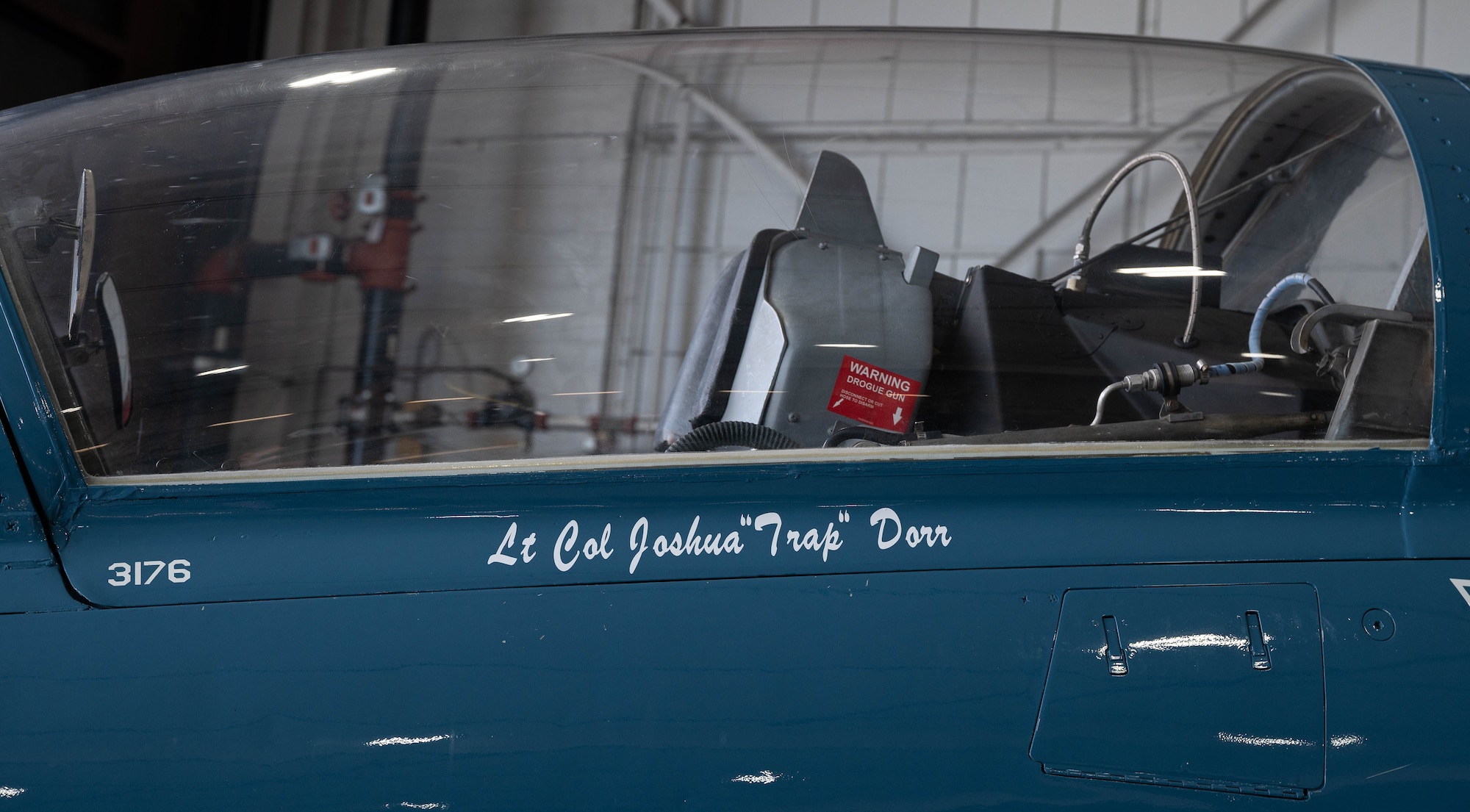 A jet displays the name of an Airman.