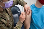 Air Force Tech. Sgt. Elizabeth Nardo, 158th Fighter Wing, Vermont Air National Guard, injects James Bordeaux with a dose of COVID-19 vaccine at Camp Johnson, Vermont, March 18, 2021. The Vermont National Guard has begun offering vaccination to Vermont residents in support of the Vermont Department of Health. (U.S. Army National Guard photo by Marcus Tracy)