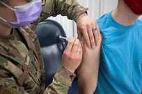 Air Force Tech. Sgt. Elizabeth Nardo, 158th Fighter Wing, Vermont Air National Guard, injects James Bordeaux with a dose of COVID-19 vaccine at Camp Johnson, Vermont, March 18, 2021. The Vermont National Guard has begun offering vaccination to Vermont residents in support of the Vermont Department of Health. (U.S. Army National Guard photo by Marcus Tracy)