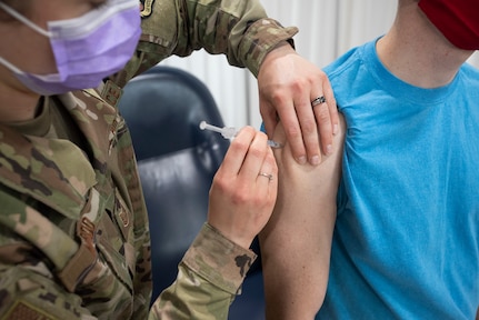 Air Force Tech. Sgt. Elizabeth Nardo, 158th Fighter Wing, Vermont Air National Guard, injects James Bordeaux with a dose of COVID-19 vaccine at Camp Johnson, Vermont, March 18, 2021. The Vermont National Guard has begun offering vaccination to Vermont residents in support of the Vermont Department of Health. (U.S. Army National Guard photo by Marcus Tracy)