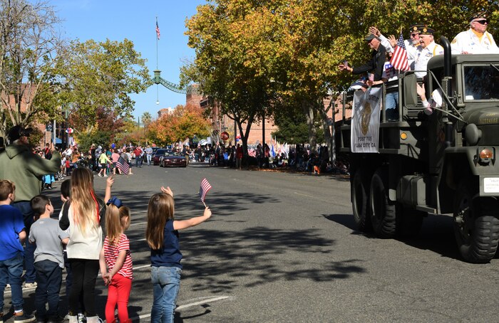Veterans wave to parade onlookers during a Veterans Day Parade Nov. 11, 2021, in Marysville, California.
