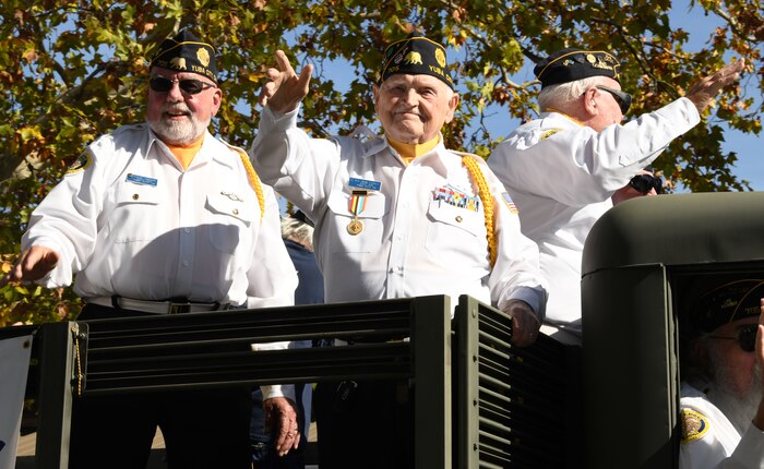 Veterans wave to parade onlookers during a Veterans Day Parade Nov. 11, 2021, in Marysville, California.