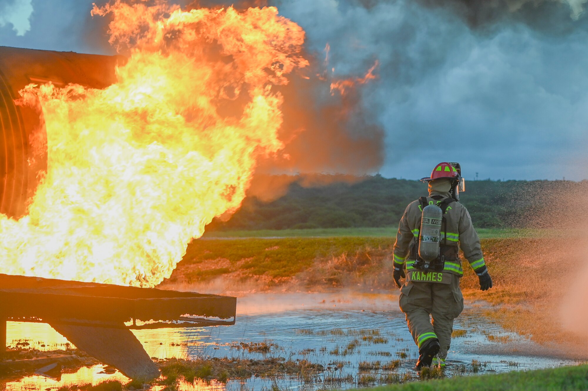 A firefighter putting out an aircraft fire.