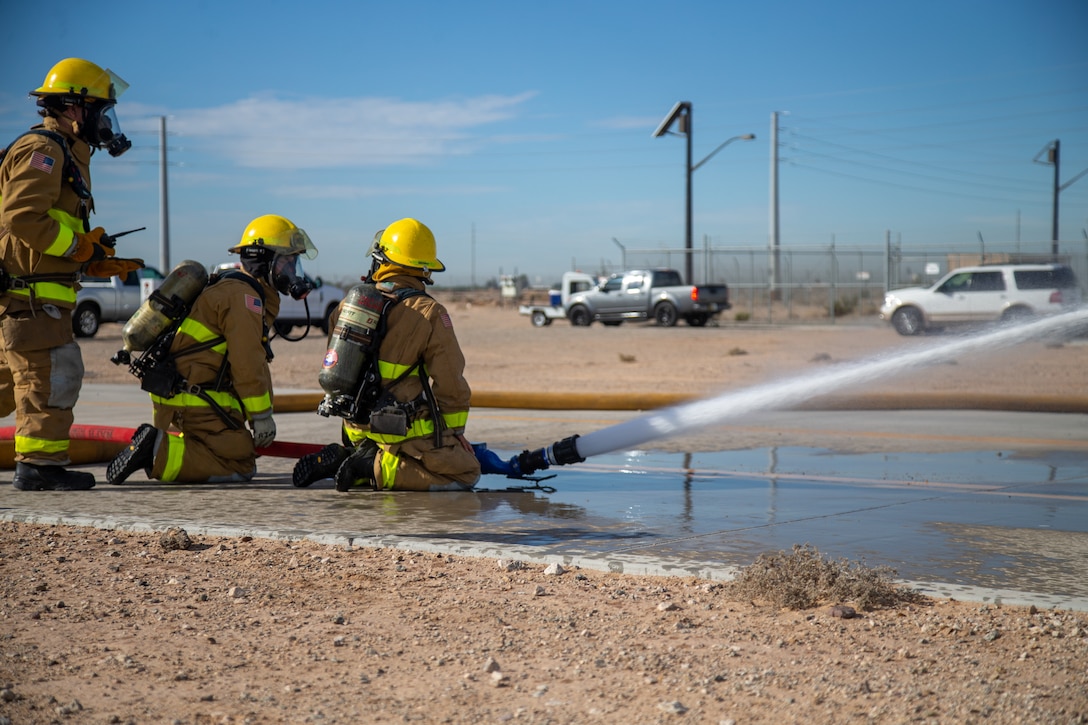 Fire Fighters with Marine Corps Air Station (MCAS) Yuma, Ariz. spray water to neutralize a simulated gas leak during exercise Desert Plume, Nov. 2, 2021.