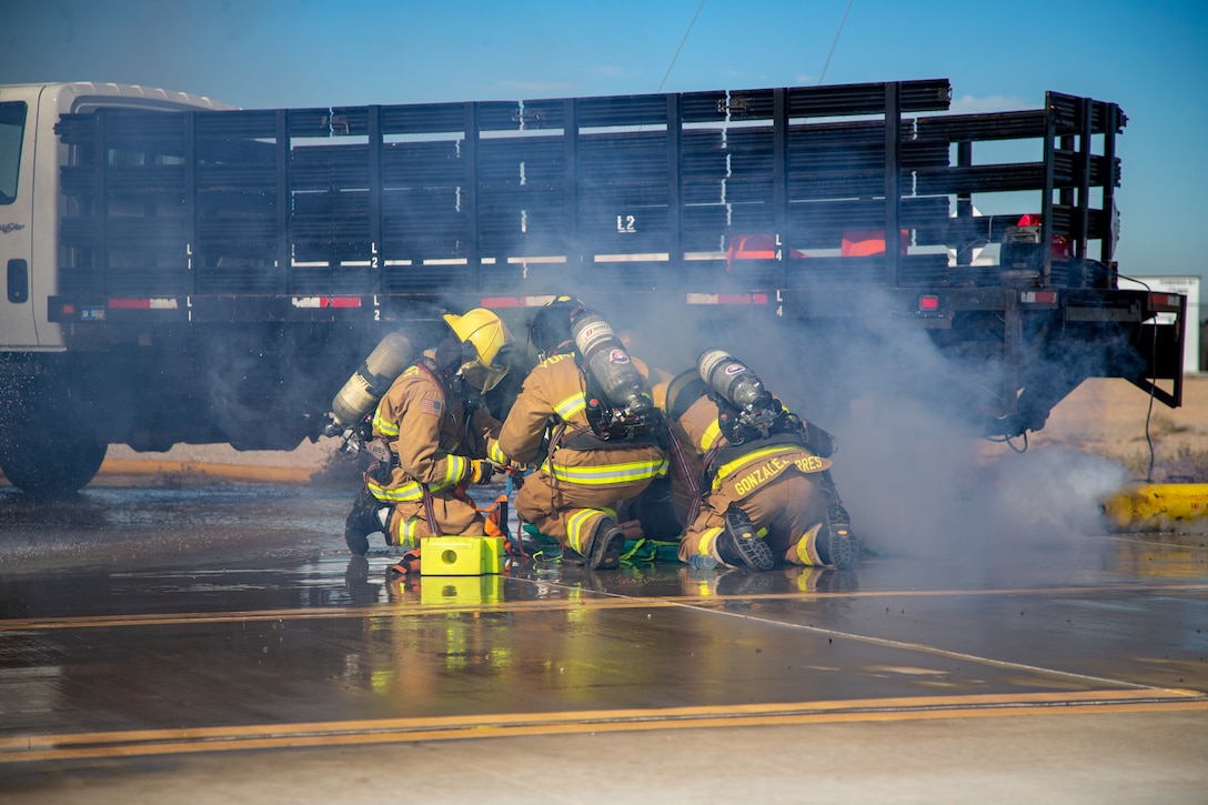 Fire Fighters with Marine Corps Air Station (MCAS) Yuma, Ariz. perform life saving techniques on a simulated casualty during exercise Desert Plume, Nov. 2, 2021. Desert Plume is a training event that evaluates MCAS Yuma’s ability to respond to a CBRNE/HAZMAT incident quickly and efficiently. (U.S. Marine Corps photo by Cpl. Gabrielle Sanders)