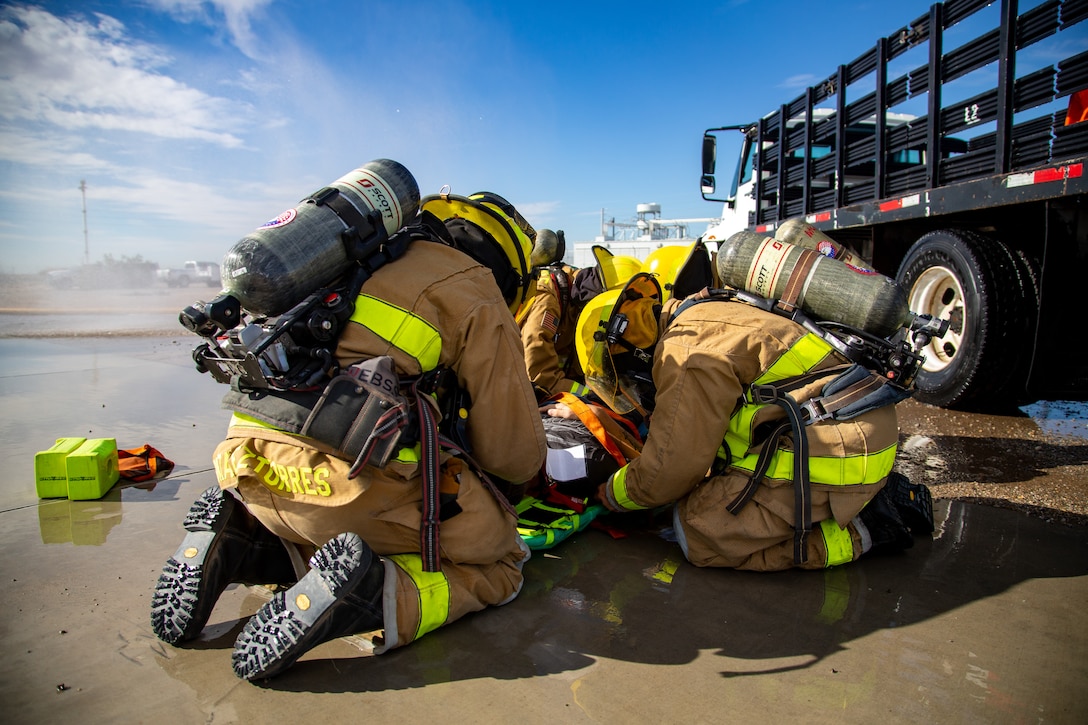 Fire Fighters with Marine Corps Air Station (MCAS) Yuma, Ariz. perform life saving techniques on a simulated casualty during exercise Desert Plume, Nov. 2, 2021.