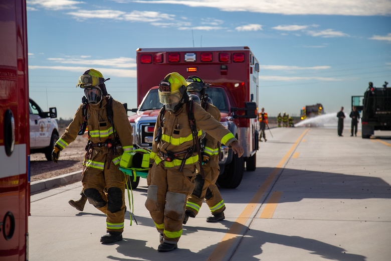 Fire Fighters with Marine Corps Air Station (MCAS) Yuma, Ariz. evacuate a simulated casualty to safety during exercise Desert Plume, Nov. 2, 2021. Desert Plume is a training event that that evaluates MCAS Yuma’s ability to respond to a CBRNE/HAZMAT incident quickly and efficiently. (U.S. Marine Corps photo by Cpl. Gabrielle Sanders)