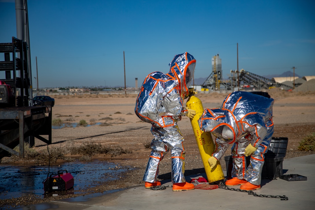 Fire Fighters with Marine Corps Air Station (MCAS) Yuma, Ariz. neutralize a simulated gas leak during exercise Desert Plume, Nov. 2, 2021. Desert Plume is a training event that evaluates MCAS Yuma’s ability to respond to a CBRNE/HAZMAT incident quickly and efficiently. (U.S. Marine Corps photo by Cpl. Gabrielle Sanders)