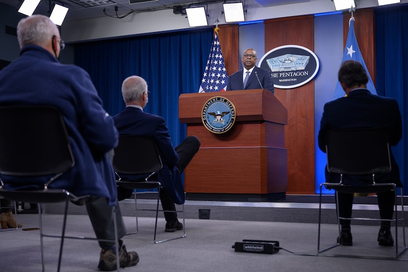 A man speaks from a podium to an audience.