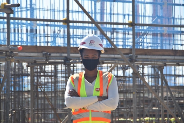 Nicole Hill, the 2021 Women of Color STEM Conference Technology Rising Star awardee and a U.S. Army Corps of Engineers Far East District project engineer, stands proudly in front of the Pet Care Center project site at USAG Humphreys, November 2020.