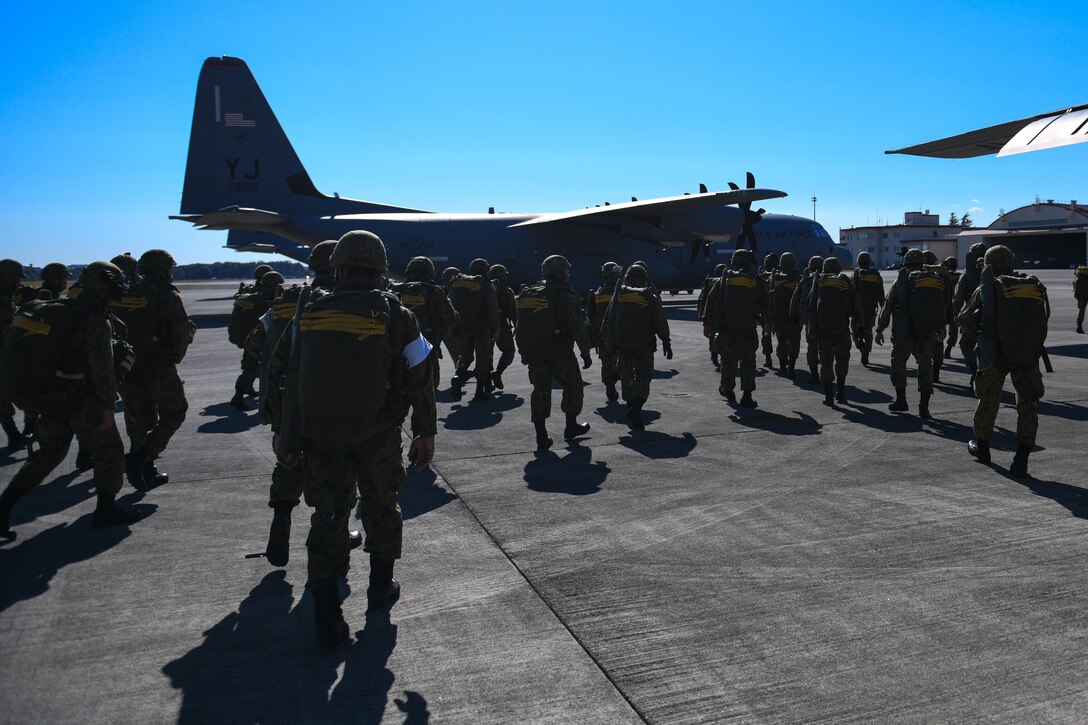 Japan Ground Self-Defense Force soldiers gather next to a U.S. Air Force C-130J