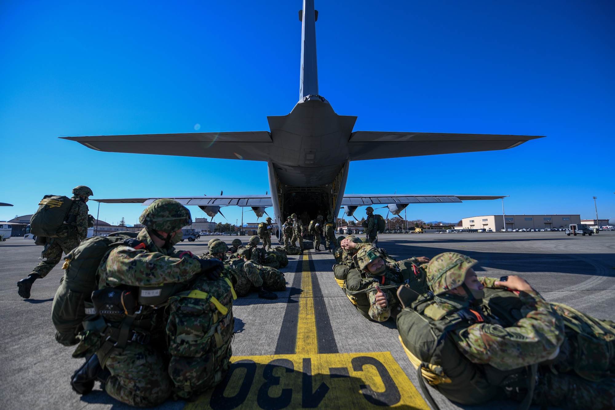 Japan Ground Self-Defense Force soldiers line up outside a C-130J