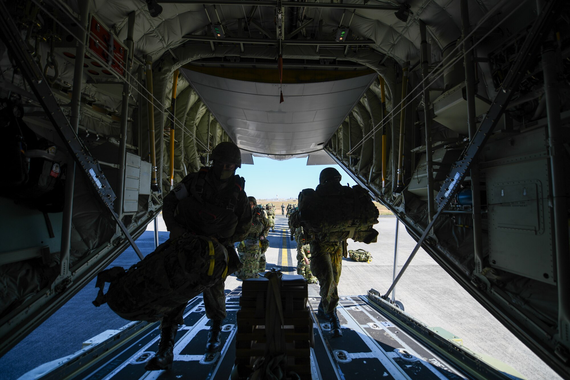 Japan Ground Self-Defense Force soldiers step inside a C-130J