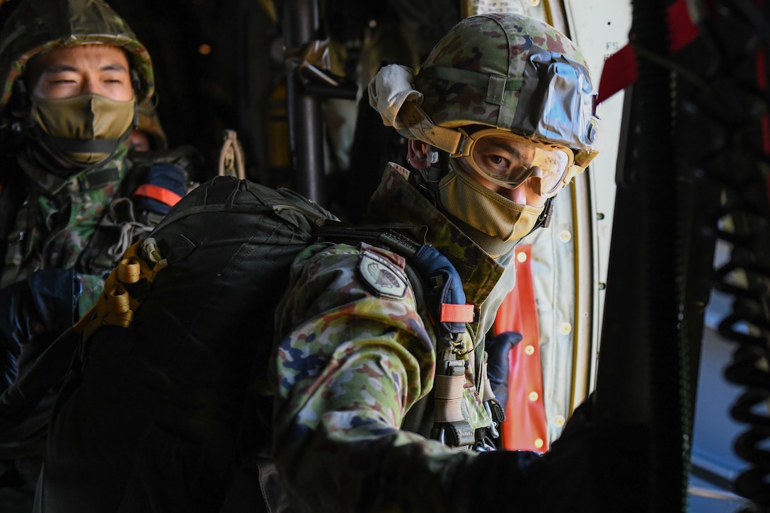 A Japan Ground Self-Defense Force soldier prepares to jump from a C-130J