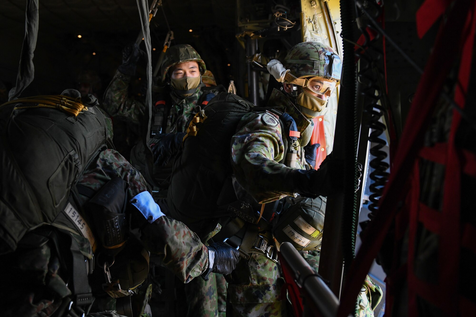 A Japan Ground Self-Defense Force soldier prepares to jump from a C-130J
