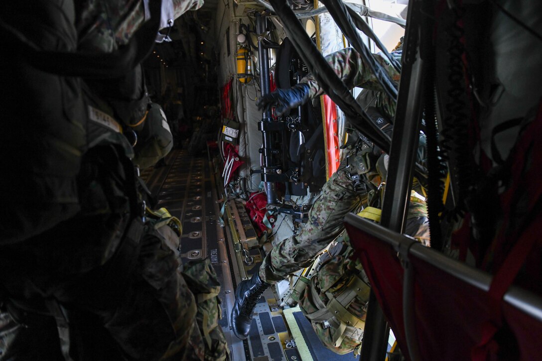 A Japan Ground Self-Defense Force soldier jumps from a C-130J