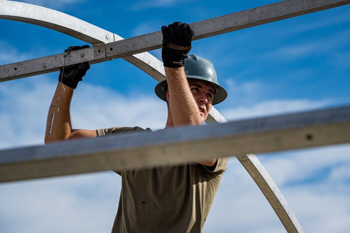 Airmen gathers around a whole